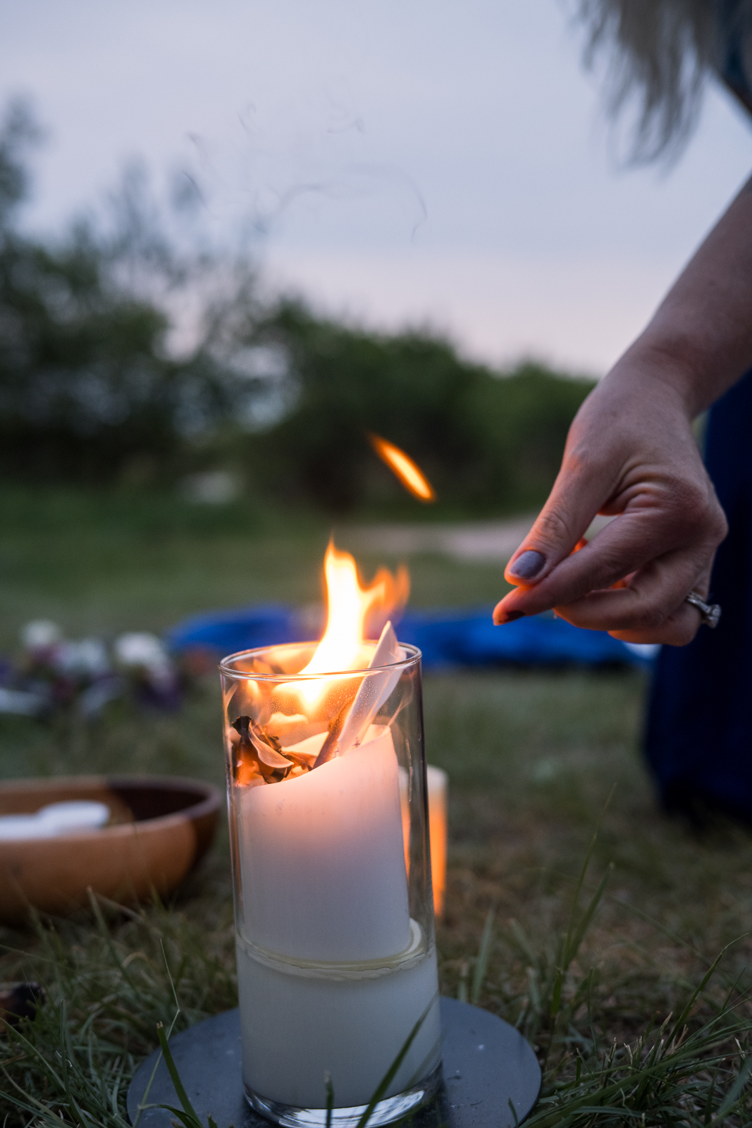 Lighting a fire ceremony candle at dusk