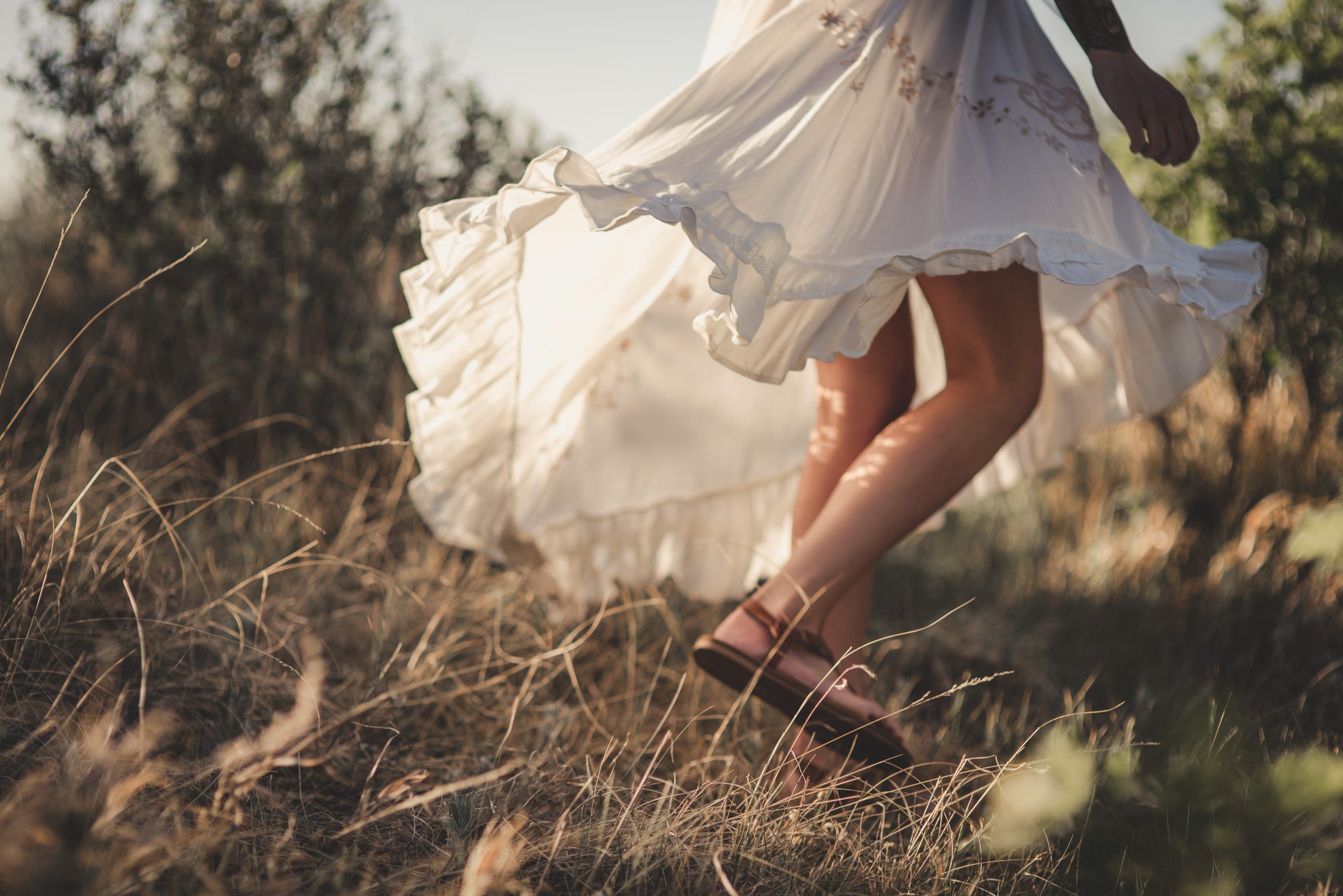 Woman moving joyfully through a golden meadow